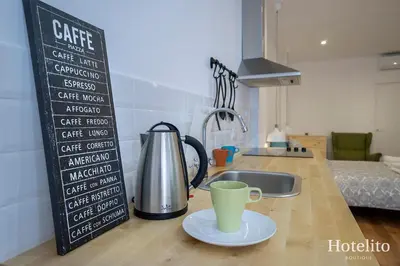 a cup on a plate on a kitchen counter with a coffee mug at Hotelito Boutique Badalona. in Badalona