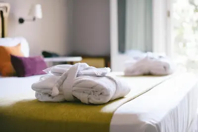 a pile of towels sitting on top of a bed at Circa 1905 in Barcelona