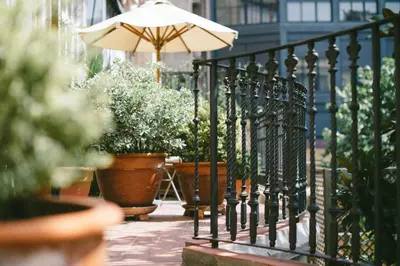 a fence with potted plants and an umbrella at Circa 1905 in Barcelona