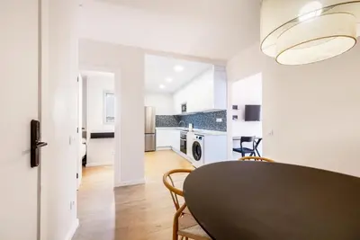 a kitchen and dining room with a table and chairs at AinB Barcelona Sants Apartments in Barcelona