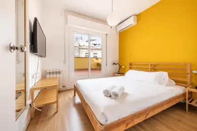a bedroom with a bed with two towels on it at AinB Barcelona Sants Apartments in Barcelona