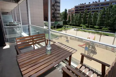 a bottle of water sitting on a wooden bench on a balcony at 1215 - Ciutadella Pretty Apartment in Barcelona
