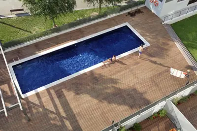 an overhead view of a swimming pool on a wooden deck at 1216 - Forum Gardens Apartment in Barcelona