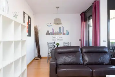a living room with a brown leather couch at 1216 - Forum Gardens Apartment in Barcelona