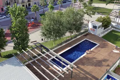 an overhead view of a swimming pool on a wooden deck at 1217 - POOL AND BEACH NICE APARTMENT II in Barcelona