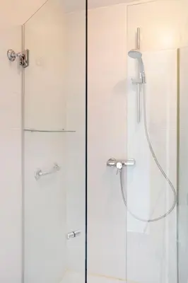 a bathroom with a shower with a glass door at 1217 - POOL AND BEACH NICE APARTMENT II in Barcelona