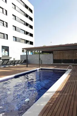 a swimming pool in front of a building at 1217 - POOL AND BEACH NICE APARTMENT II in Barcelona