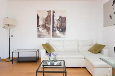 a living room with a white couch and a table at 1217 - POOL AND BEACH NICE APARTMENT II in Barcelona