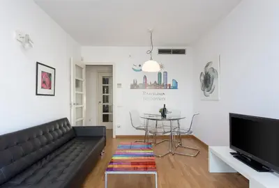 a living room with a black couch and a table at 1214 - TWO BEDROOMS CIUTADELLA APARTMENT in Barcelona