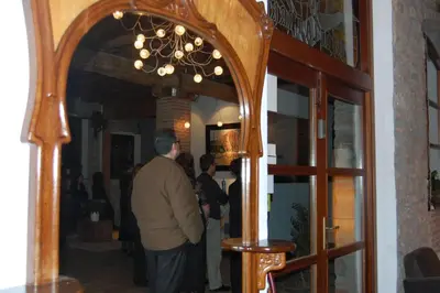 a group of people standing in a room with a chandelier at Hotel Moli De La Torre in Bigues i Riells
