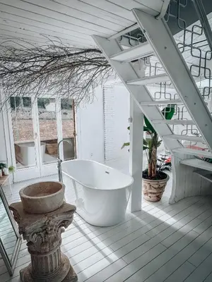a large white bathroom with a tub and stairs at Suite con Jacuzzi in Canyelles