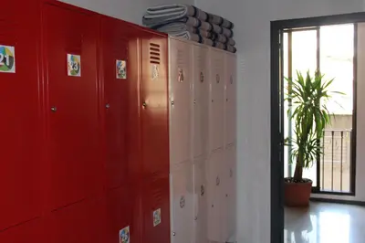 a row of red lockers in a locker room at Alternative Creative Youth Hostel Barcelona in Barcelona