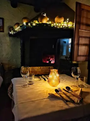 a table with wine glasses and a lamp on it at Masia Can Felip B&B in Llinars del Vallès