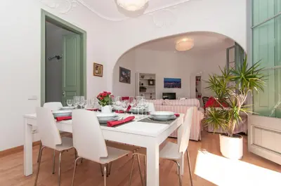 a white dining room with a white table and chairs at Montaber Apartment - Sant Antoni in Barcelona