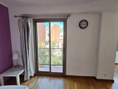 an empty room with a large window and a clock at Sagrada Familia Apartment 265 in Barcelona