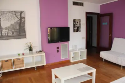 a living room with purple walls and a tv at Sagrada Familia Apartment 265 in Barcelona