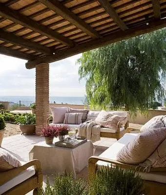 an outdoor patio with couches and a table with a table at Can Mora de Dalt in Sant Vicenç de Montalt