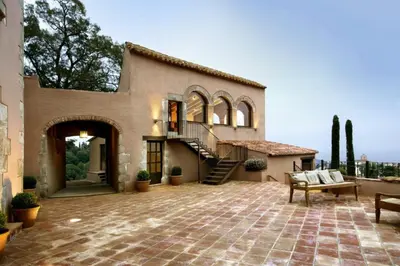 a house with a staircase and a patio at Can Mora de Dalt in Sant Vicenç de Montalt