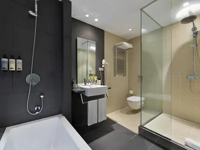 a bathroom with a shower and a sink and a toilet at H10 Casanova in Barcelona