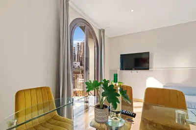 a balcony with a chair and a view of a cathedral at Suite Home Sagrada Familia in Barcelona