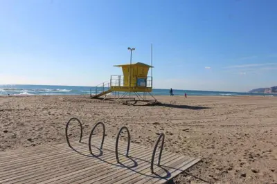 a life guard station on a beach with a playground at Family Deluxe Apartment Beach in Castelldefels