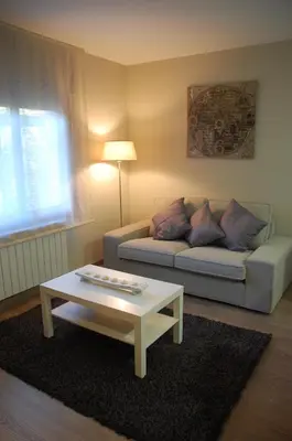 a living room with a couch and a coffee table at Montseny Suites & Apartments in Montseny