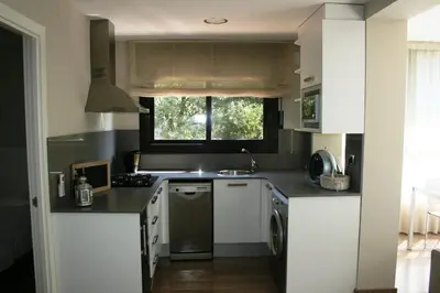 a kitchen with a sink and a dishwasher at Montseny Suites & Apartments in Montseny