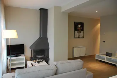 a living room with a couch and a fireplace at Montseny Suites & Apartments in Montseny