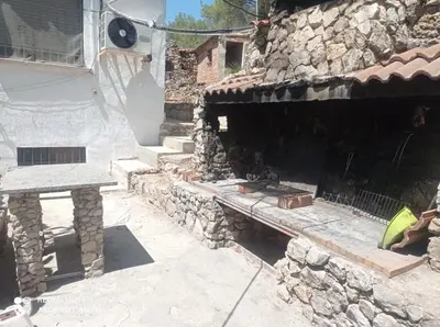 a living room with two white couches and a fireplace at Casa Calafell in Segur de Calafell