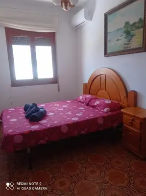 a hallway with a room with a table and a door at Casa Calafell in Segur de Calafell