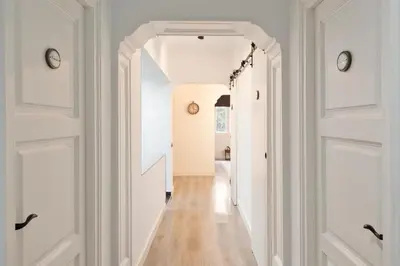 a hallway with white walls and white doors at KeyFamily Paradise in Barcelona
