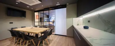 a dining room with a wooden table and chairs at Airhostel Barcelona Airport 24h in El Prat de Llobregat