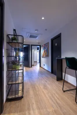 a room with a book shelf in the middle of a room at Airhostel Barcelona Airport 24h in El Prat de Llobregat