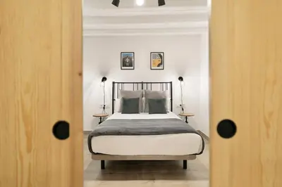 a bedroom with a bed and two side tables at KeyFamily Loft Las Ramblas in Barcelona