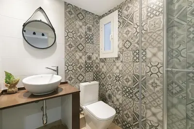 a bathroom with a toilet and a sink and a mirror at KeyFamily Loft Las Ramblas in Barcelona