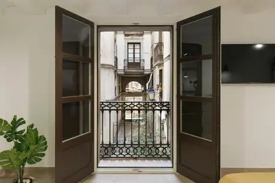 an open door with a view of a balcony at KeyFamily Loft Las Ramblas in Barcelona