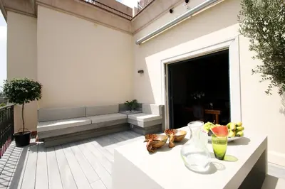 a living room with a couch and a table at Decô Apartments Barcelona-Diagonal in Barcelona