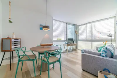 a living room with a table and chairs and a couch at Terrassa de Mar Apartment in Masnou