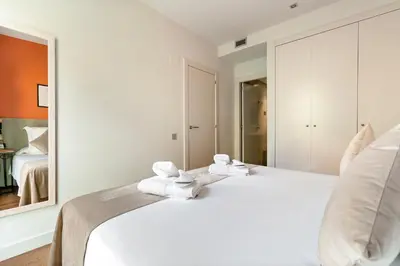 a bedroom with a white bed with towels on it at Sensation Sagrada Familia in Barcelona