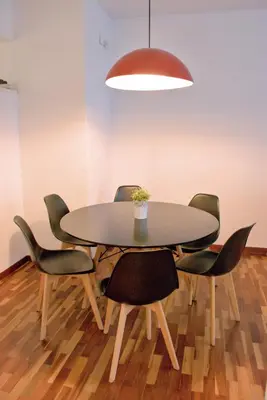 a dining room table with chairs and a pendant light at Sweet BCN Three Bedroom Apartment in Barcelona