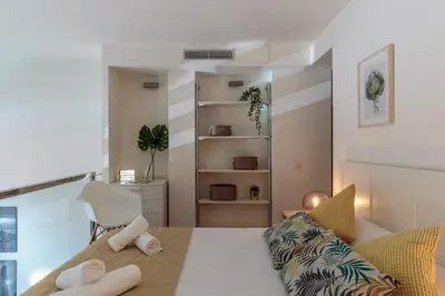a room with a bed and a chair in it at Modern and Trendy Duplex next to Paseo de Gracia in Barcelona