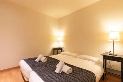 a bedroom with a bed with two pillows on it at AB Park Güell-Gaudi in Barcelona