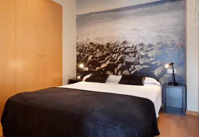 a bedroom with a large painting on the wall at AB Park Güell-Gaudi in Barcelona