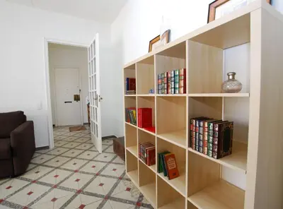 a book shelf filled with books in a living room at La casa del Pi · La casa del Pi · House in the city, next to Barcelona and beach in Badalona