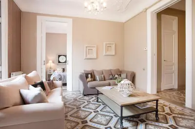 a bedroom with two beds and two mirrors on the wall at BCN Rambla Catalunya Apartments in Barcelona