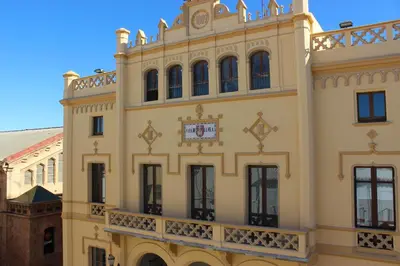 a building with a clock on the side of it at Sitges Apartment in Sitges
