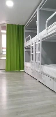 two bunk beds in a room with a green curtain at Alberguinn in Barcelona