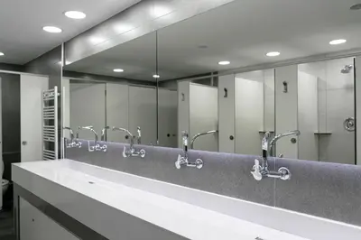 a bathroom with a row of sinks and mirrors at Alberguinn in Barcelona