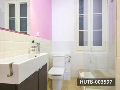 a bathroom with a sink and a toilet and windows at Big Apartment Barcelona Gran via in Barcelona