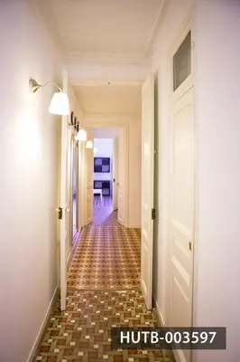 a hallway with a tile floor and a white door at Big Apartment Barcelona Gran via in Barcelona
